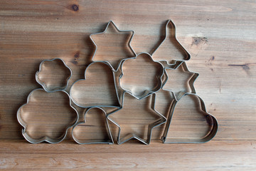 Christmas cookie cutters on wooden background 