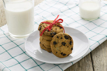 cookies and a glass with milk on wooden table
