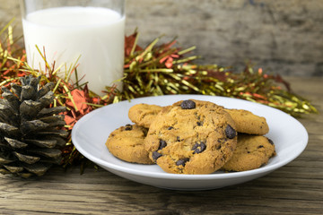 cookies and a glass with milk on wooden table