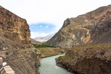 Himalayas landscape with cycling, mountains, road, river and clouds. Jammu and Kashmir State, North India