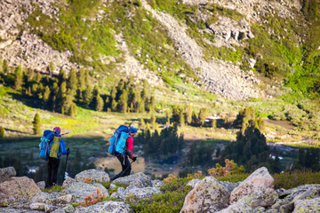 Young people are hiking in highlands of Altai mountains, Russia