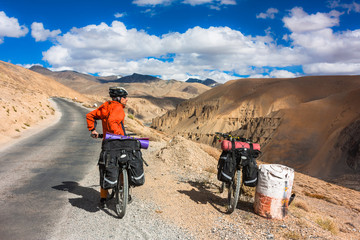 Fototapeta premium Cyclist standing on mountains road. Himalayas, Jammu and Kashmir State, North India