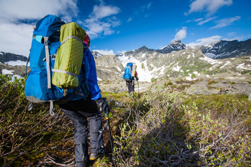 Young people are hiking in highlands of Altai mountains, Russia