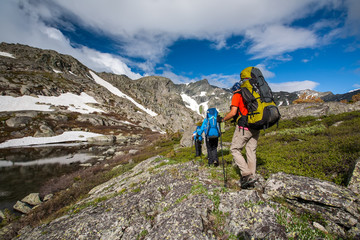 Young people are hiking in highlands of Altai mountains, Russia