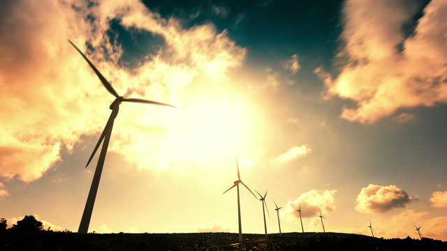 wind mill turbines on mountain timelapse with cloudy sky
