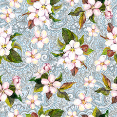 Floral repeating pattern with flowers and indian ornamental paisley design. Sakura white and pink spring flowers on ornamental background. Watercolor