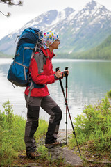 Young woman is hiking in forests of Siberia, Russia