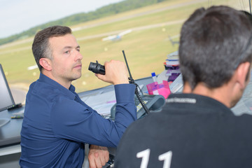 Man talking into receiver in air traffic control