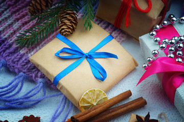 Christmas gift boxes, fir tree branch and winter scarf
