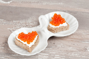 sandwich with red caviar in the form of a heart