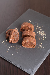 chocolate swiss roll with fruit jam on black background