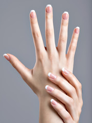 Beautiful female hands with french manicure on nails