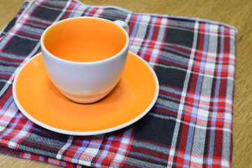 Empty coffee cup on cloth napkin