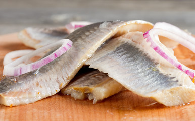 Pieces of herring fillet on a cutting board