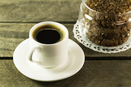Black coffee in white mug and cookies