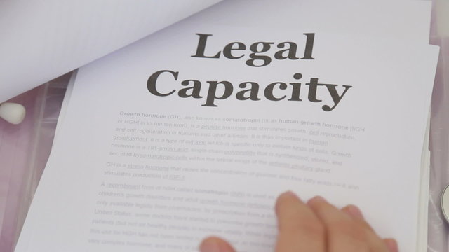 Doctor Holding Legal capacity lawsuit documents