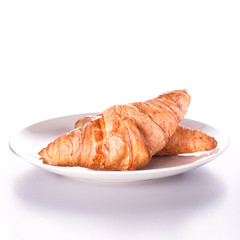 Two french croissants on plate