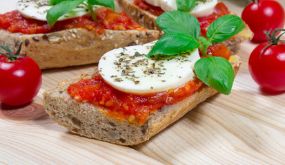 Italian bruschetta with cherry tomatoes, mozzarella & fresh basil.