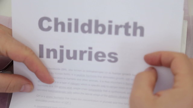 Doctor Holding Childbirth injuries papers