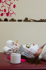 Woman with clay facial mask in beauty spa
