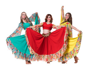 three female dancers posing, isolated on white in full length