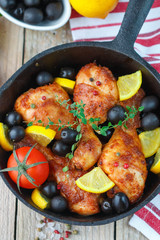 Fried chicken. Fried chicken legs with lemon and olives