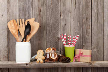 Kitchen utensils and christmas spices on shelf