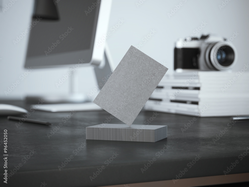 Poster stack of business cards on the table with computer.