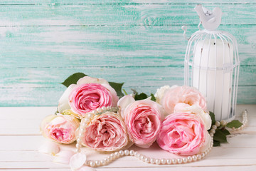 Background with  pink roses flowers, pearl and candle  in decora