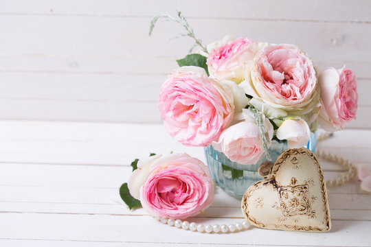 Background with sweet pink roses flowers  in blue vase and decor