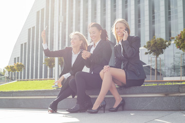 Three women using modern technology