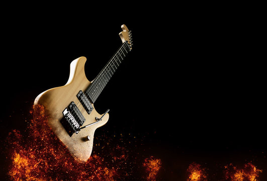 Electric Guitar in fire Isolated on Black