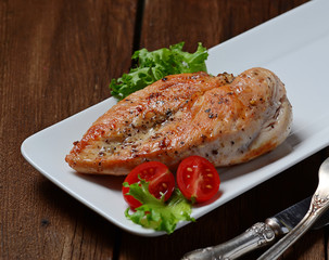 Grilled chicken breasts in white plate