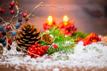 Christmas background with cones, berries, fir tree and candles,