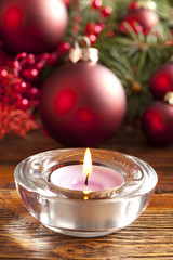 Candle and christmas baubles and tree