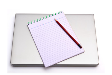 Notepad with pencil Isolated on top of latop