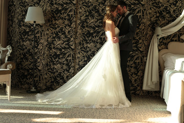 beautiful couple, groom and bride wear wedding clothes,embracing  in bedroom - 96456866
