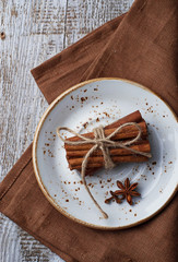 Cinnamon sticks in white plate