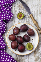 Sweet fresh plums on wooden table