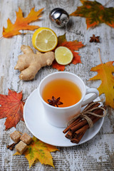 Ginger, lemon and cop of tea on light background