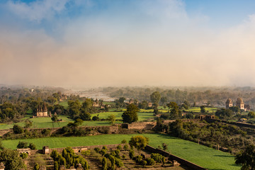 Mist clearing at dawn over river Betwa near Orchha in India.