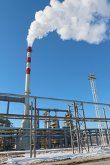 Modern oil refinery factory (petroleum refinery) against a blue sky