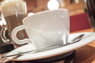 Cup of coffee stands on a table in cafeteria
