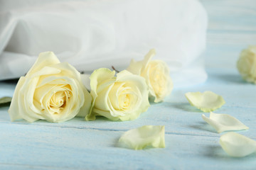 Fototapeta na wymiar Bouquet of white roses on blue wooden background