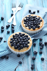 Homemade blueberry tart on blue wooden table