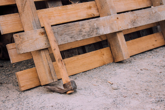 Wooden pallet and adze