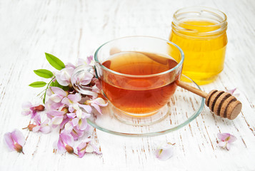 Cup of tea and acacia flowers