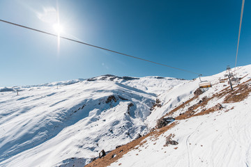 Ski lifts durings bright winter day