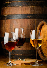 Wine glasses on barrel background