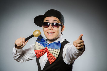 Funny man with mic in karaoke concept